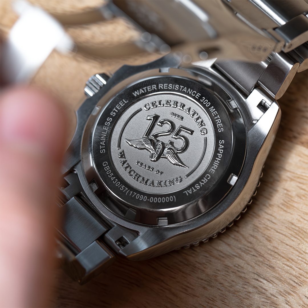 Rotary Seamatic watch facing dial down on a table with a special edition caseback that reads 'celebrating over 125 years of watchmaking'
