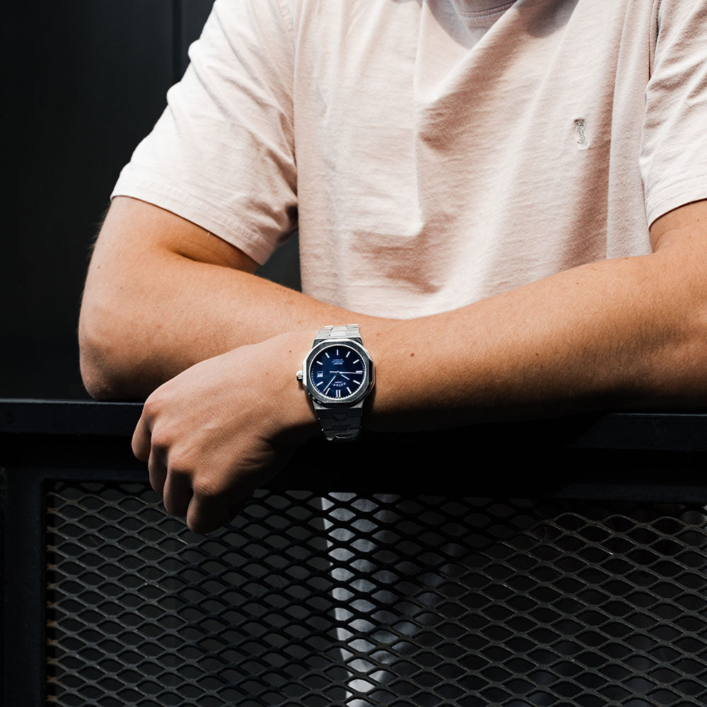 a man wearing a rotary watch in stainless steel with a blue dial